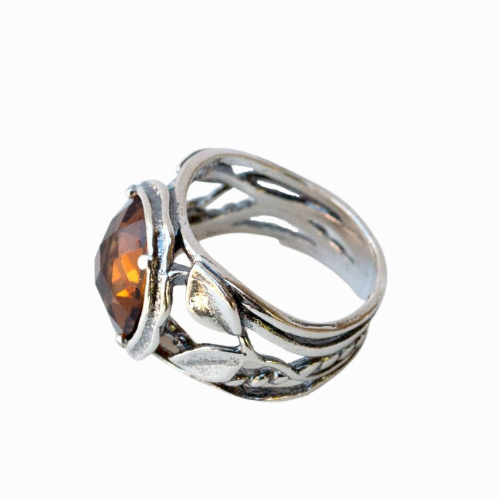 Silver Ring- Smoky quartz ring. Artisan-crafted with a faceted light colored smoky quartz. An alternative view from the side is shown on a white background. 