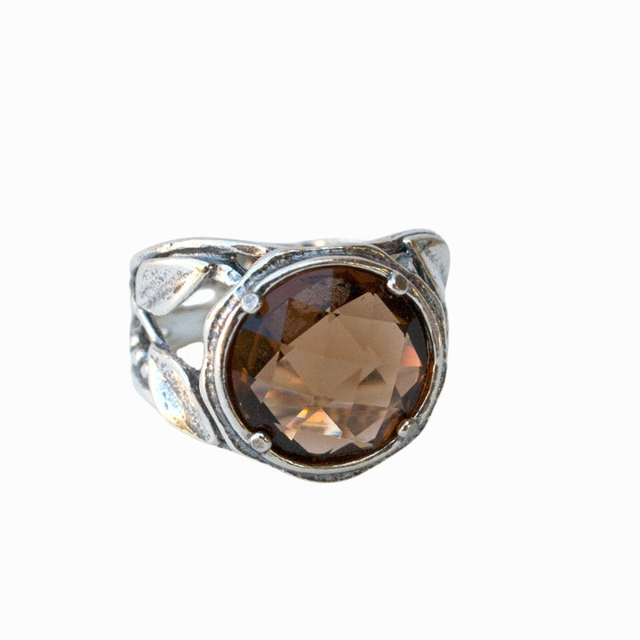 Silver Ring- Smoky quartz ring. Artisan-crafted with a faceted light colored smoky quartz. Shown from the front on a white background. 