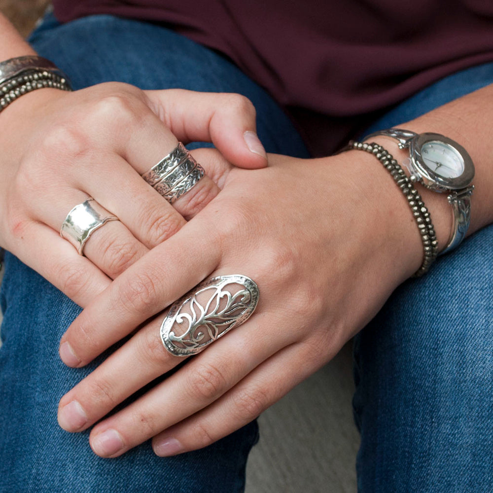 Sterling silver hammered band ring shown on a model with other rings.