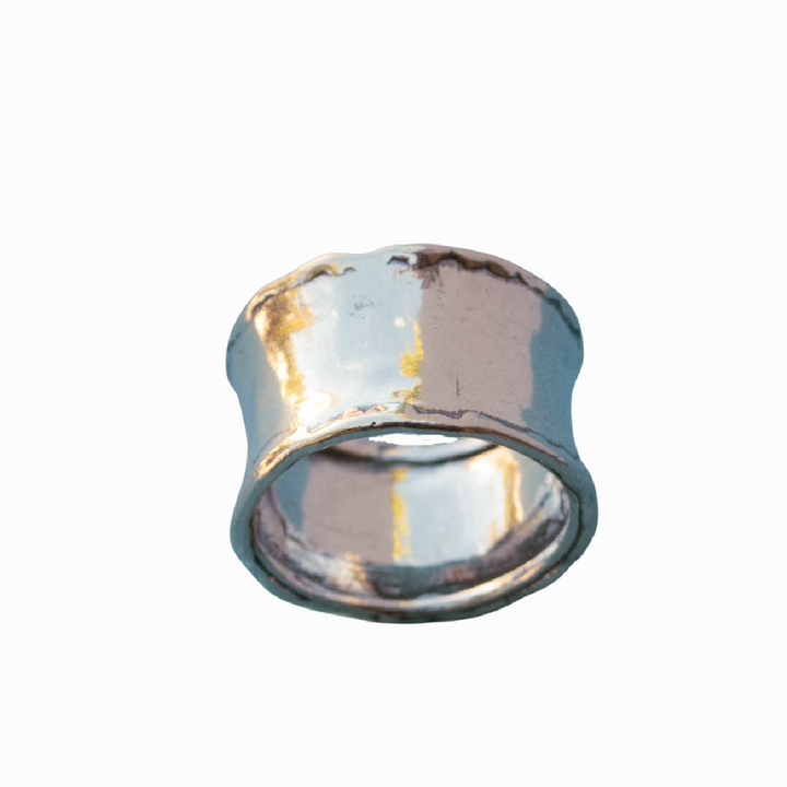A silver ring with a hammered texture, wide band, and a .925 sterling silver stamp on a white background