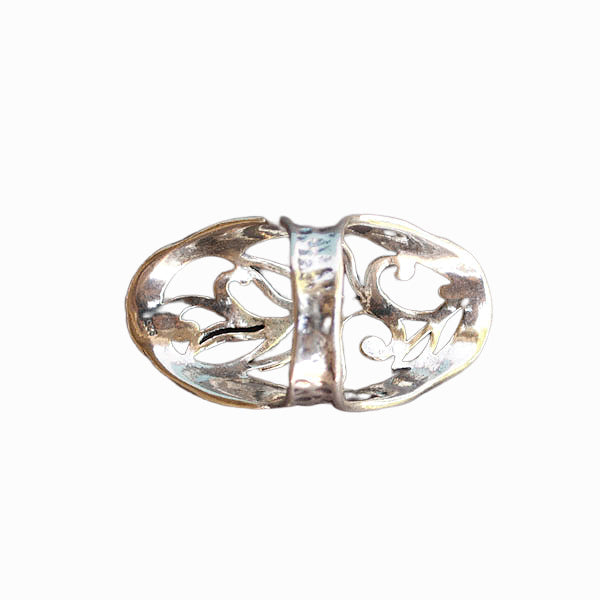 A sterling silver ring with intricate open scroll work, slightly oxidized for depth and detail, is shown from the back on a white background. 