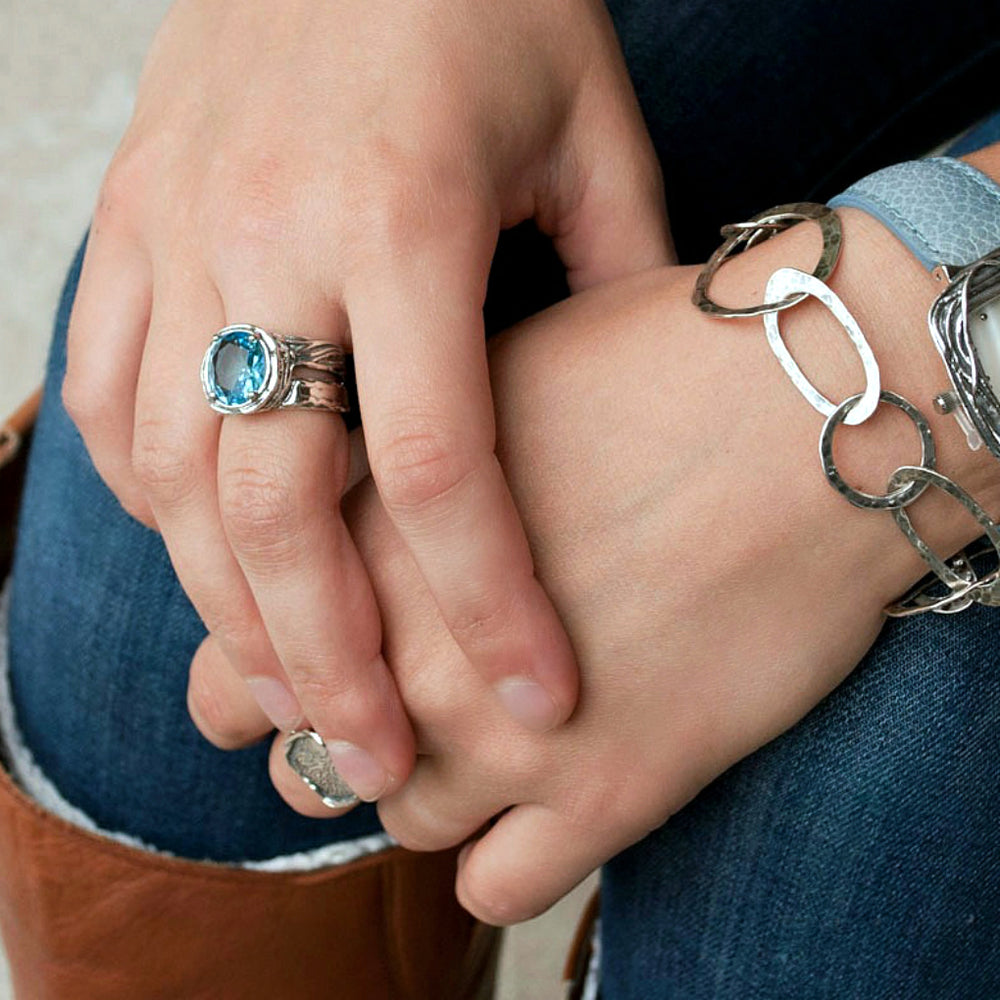 Silver Ring - artisan-crafted in .925 sterling silver with a faceted blue topaz, shown on a model.  