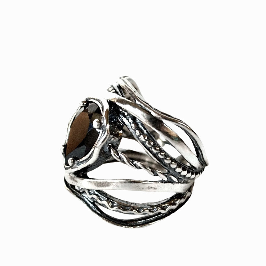 Silver and Black Onyx ring- artisan-crafted of .925 sterling silver and black onyx. The stone is pear-shaped. Side view shown on a white background. 