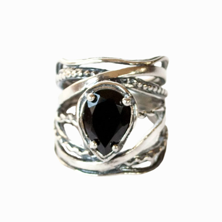 Silver and Black Stone Ring- artisan crafted of .925 sterling silver with a cabochon of black onyx. Tear-shaped stone is shown on a white background. 