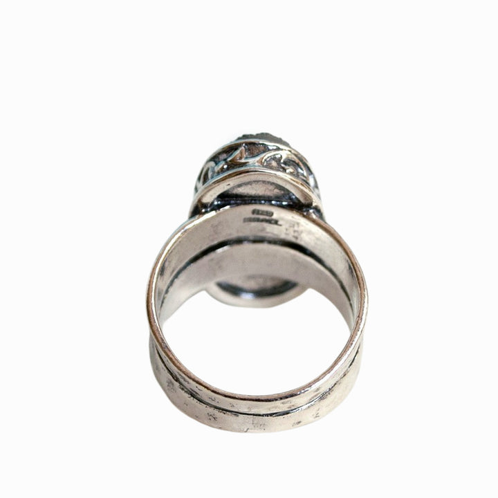 A sterling silver ring with a central oval-shaped druzy quartz stone, featuring a double-hammered band and a comfort fit design. A back view is shown on a white background.