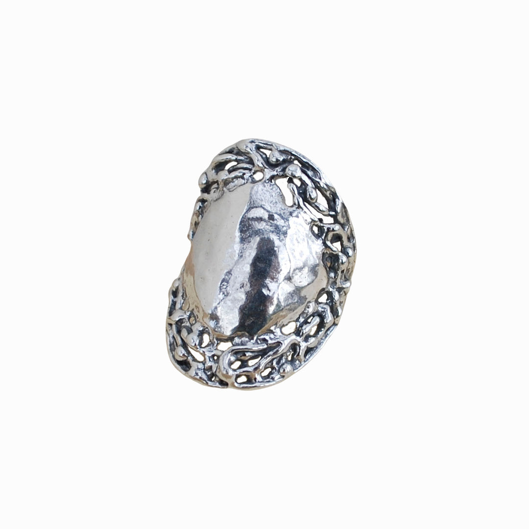 A sterling silver ring with a textured, organic border with a prominent, rounded hammered surface. Shown on a white background.