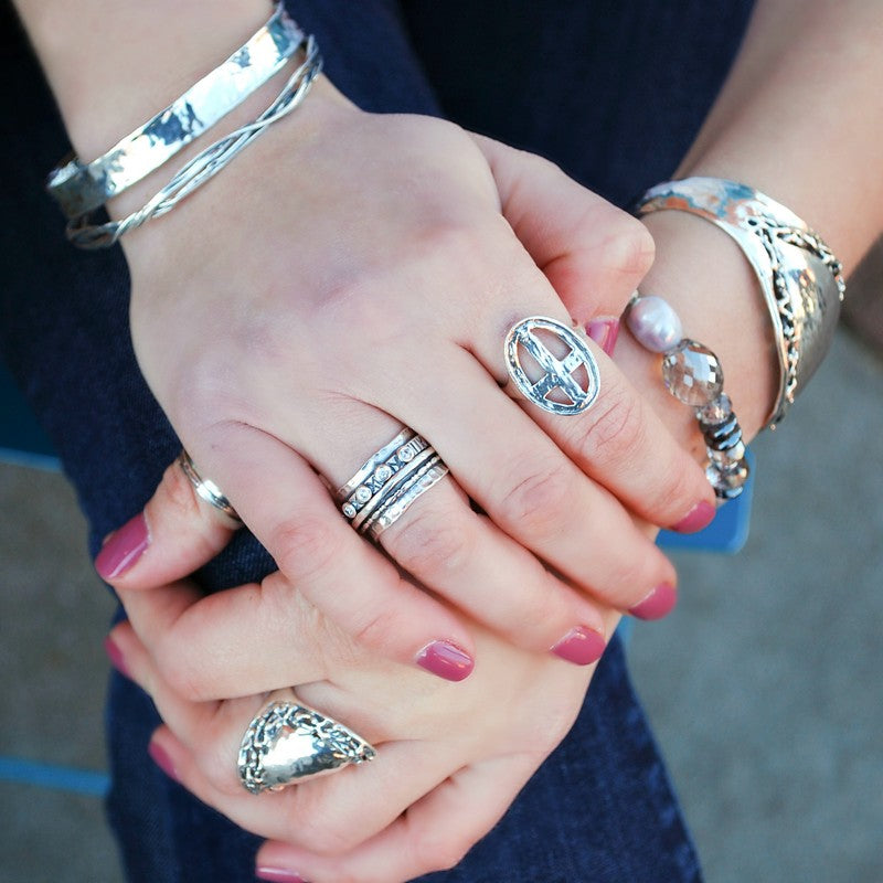 Cross Ring- crafted in .925 sterling silver, an open cross in an oval design. Shown on a model.