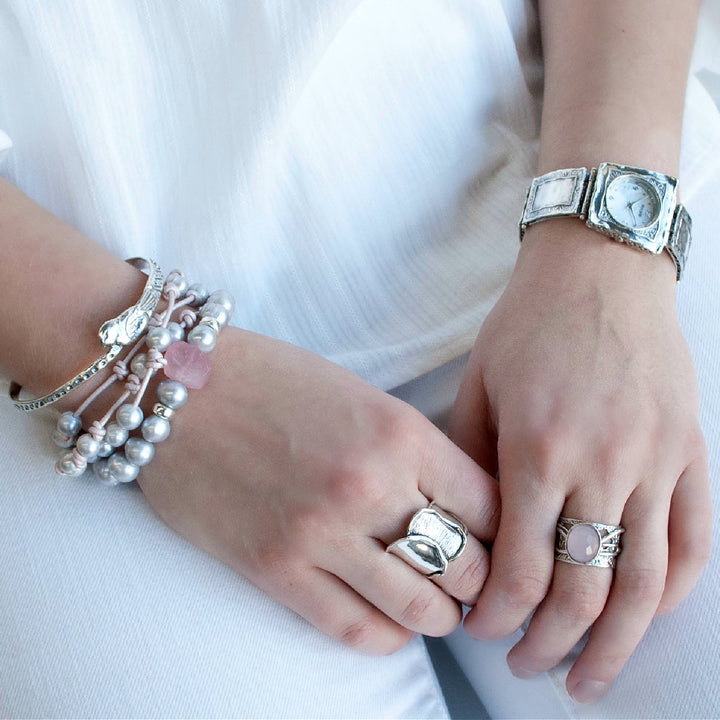 Pink Ring- .925 sterling silver ring with a faceted rose colored agate. Shown on a model.