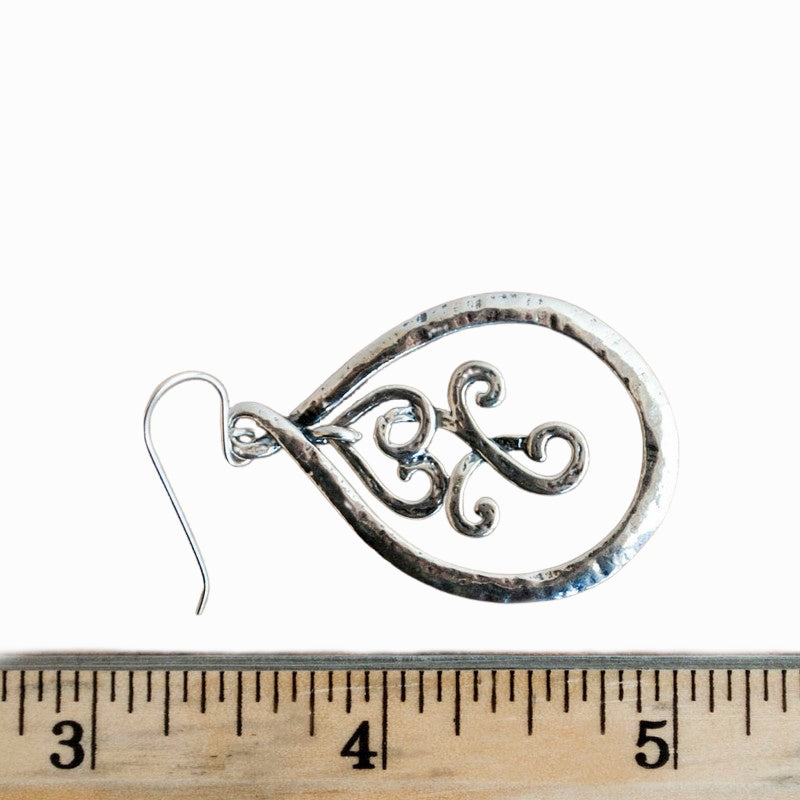 Sterling silver dangle earrings with an inner scrolled part that creates great movement. Shown with a ruler for size.  2" long.