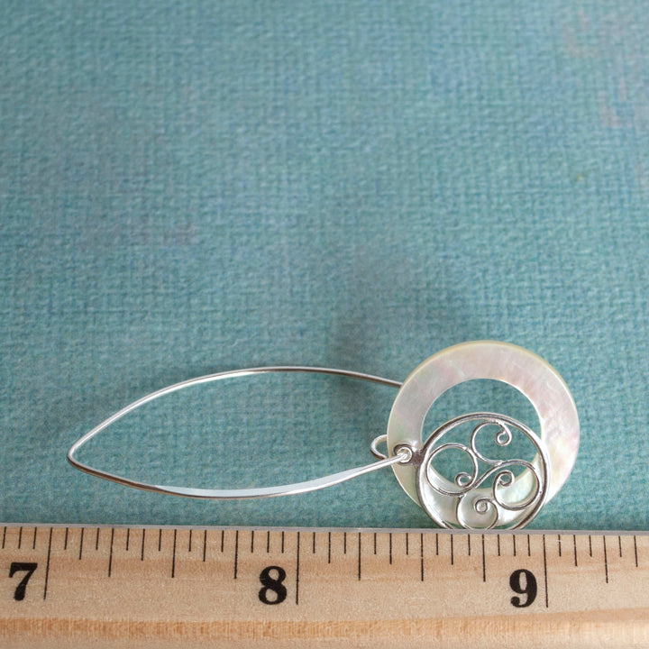 Long Earrings with sterling silver filagree and mother-of-pearl. Displayed by a ruler for sizing. 