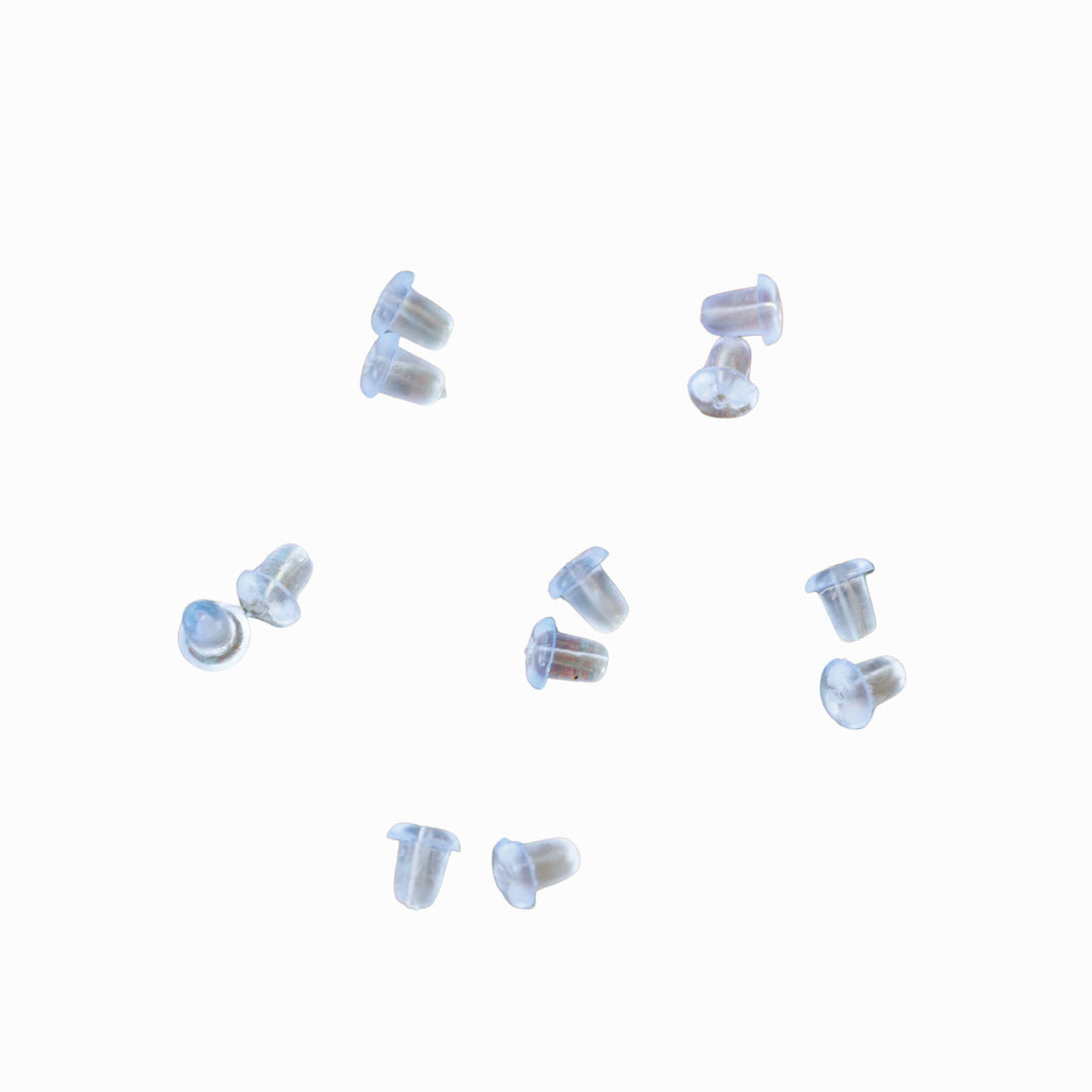 6 pairs of clear plastic earring backs shown on a white background. 