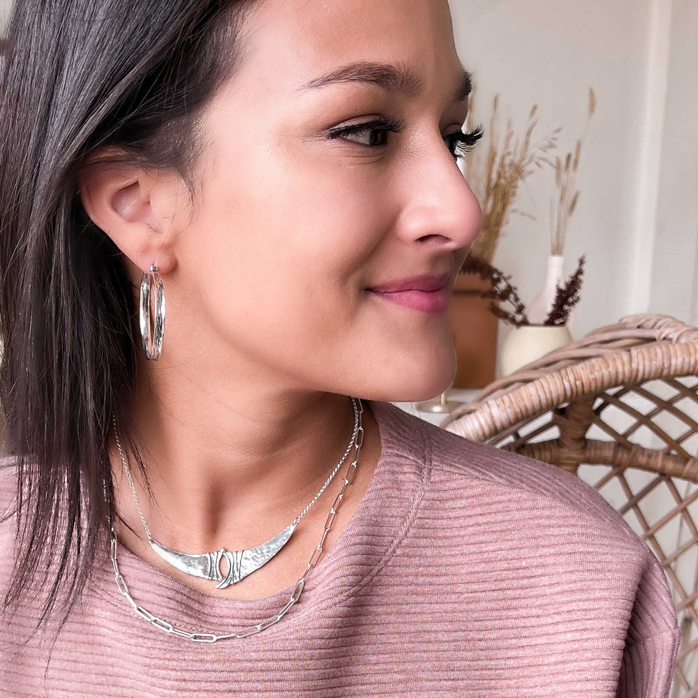 Around We Go sterling silver hoop earrings worn on a model, showing their 2 1/2-inch statement size.