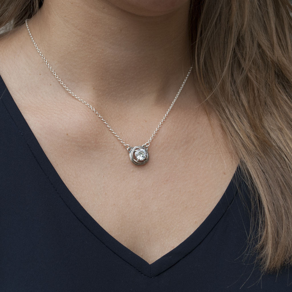 Silver Necklace with a centered clear CZ link. Artisan-crafted necklace is made of .925 stelring silver with clear cz. Shown on a model.