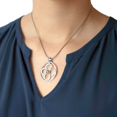 Sterling Silver Necklace With Flower Design and a Labradorite Center. Artisan-crafted of .925 sterling silver. Shown on a model.