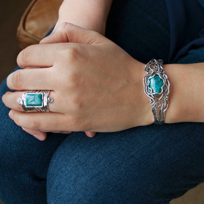 Sterling silver ring with a rectangle cabochon of stabilized turquoise. Shown on a model.